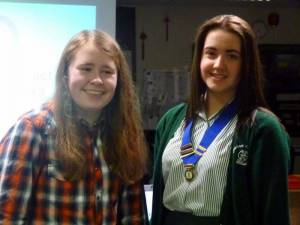 Outgoing President of Greenbank Interact Club, hands over her badge of office to this years President.